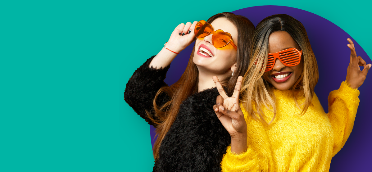 Two girls in funny sunglasses smiling.