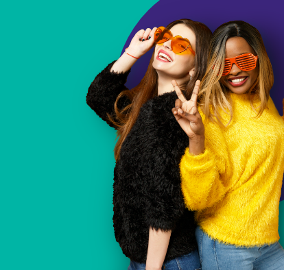 Two girls in funny sunglasses smiling.