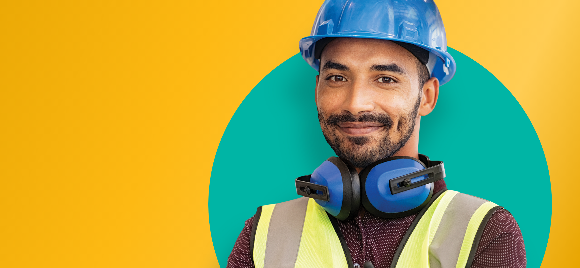 Smiling construction worker with a blue hard hat and blue earphones.