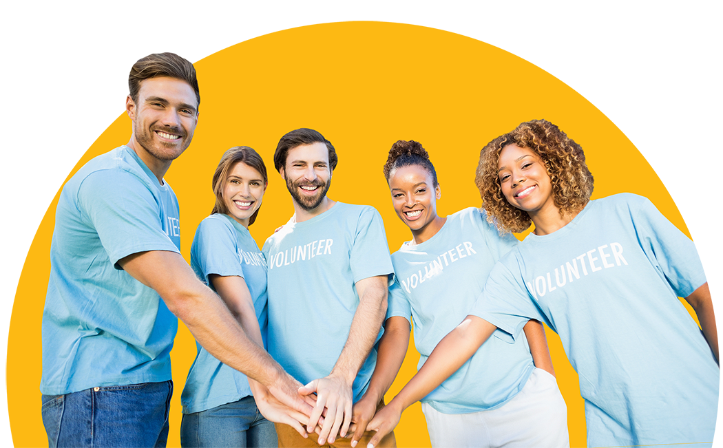 Group of diverse volunteers smiling and joining hands.