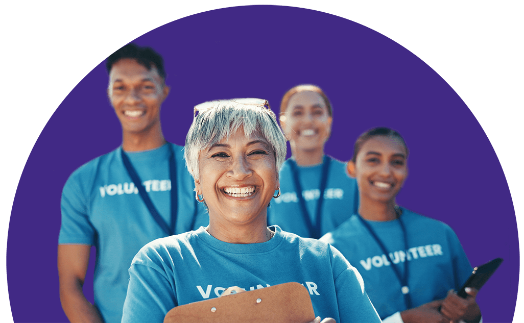 Smiling senior volunteer with clipboard and team, symbolizing support for community involvement.
