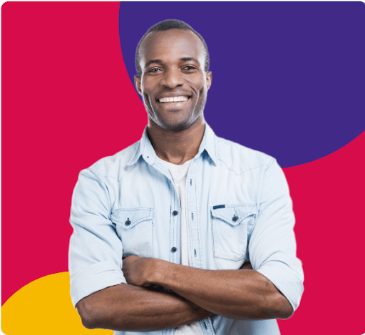 Smiling man with arms crossed in front of a colorful background.