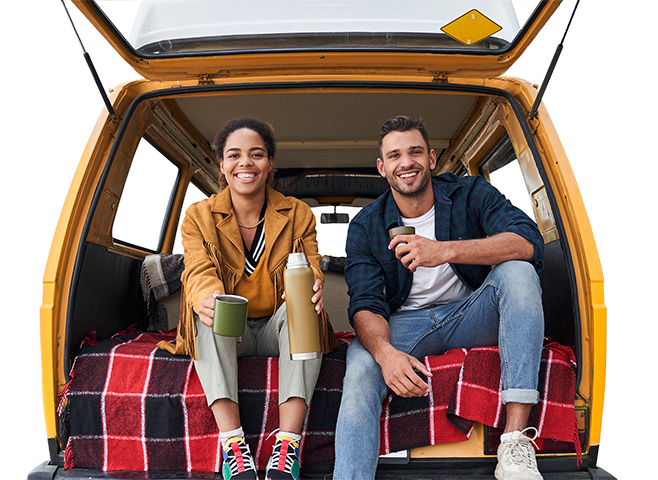 Couple enjoying coffee in back of a car on a road trip.