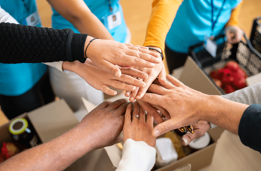 Moneytree team members joining hands during local charity event.