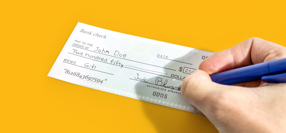 Handwriting on a bank check for $250, demonstrating check cashing services at Moneytree.